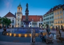 Hlavné námestie and Roland Fountain's light show at dusk in Bratislava, Slovakia